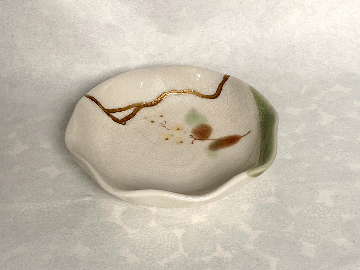 Beige ramekin with green and brown