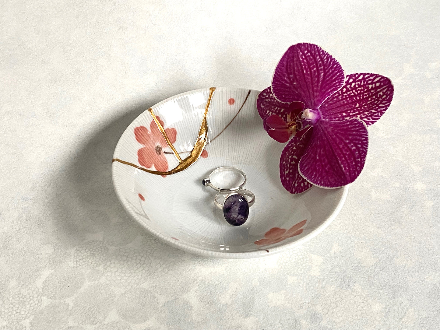 White ramekin with pink cherry blossoms