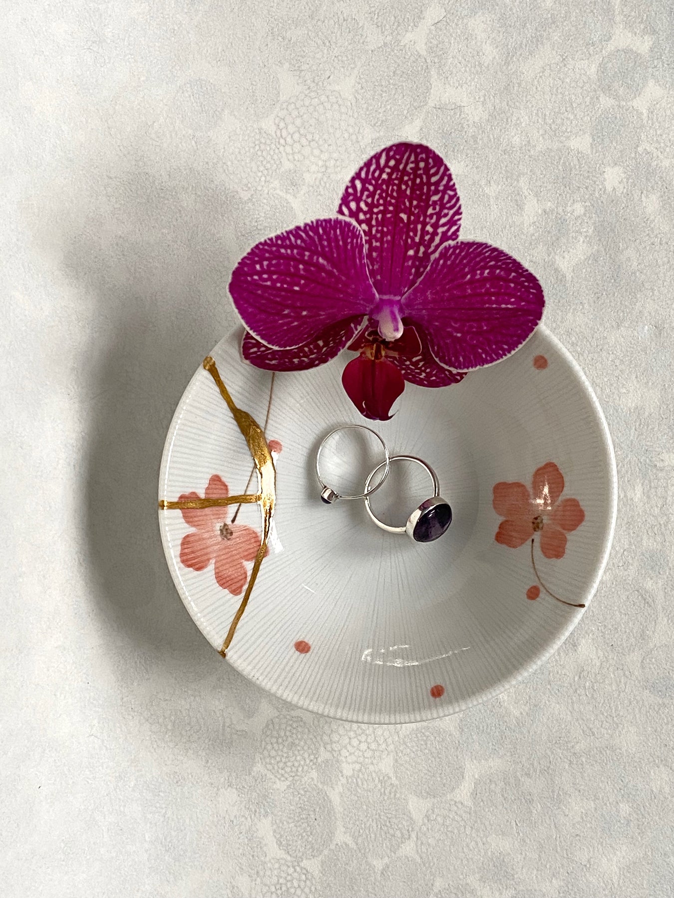 White ramekin with pink cherry blossoms