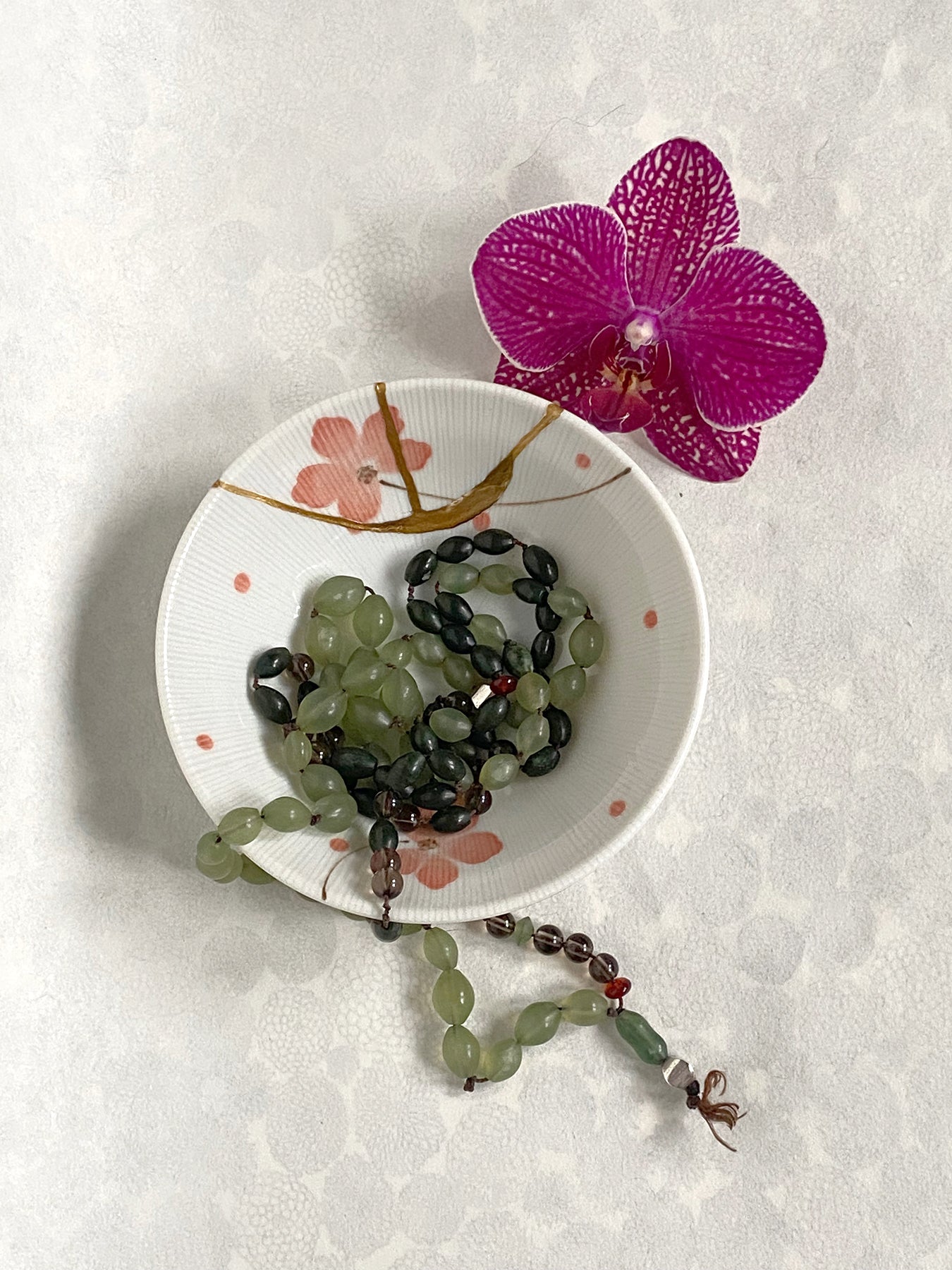 White ramekin with pink cherry blossoms