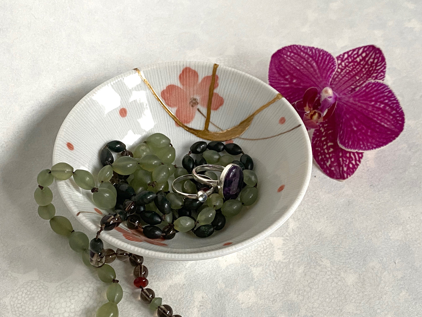 White ramekin with pink cherry blossoms