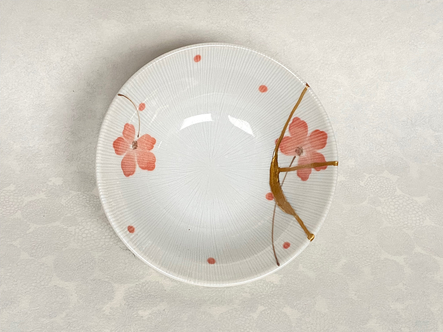 White ramekin with pink cherry blossoms