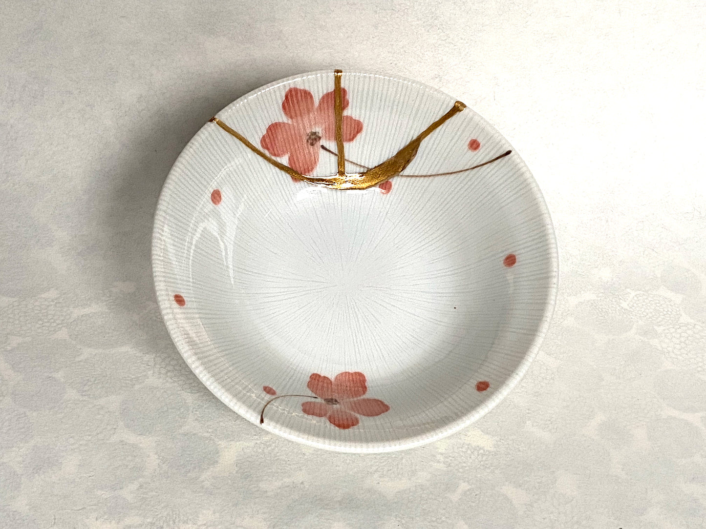 White ramekin with pink cherry blossoms