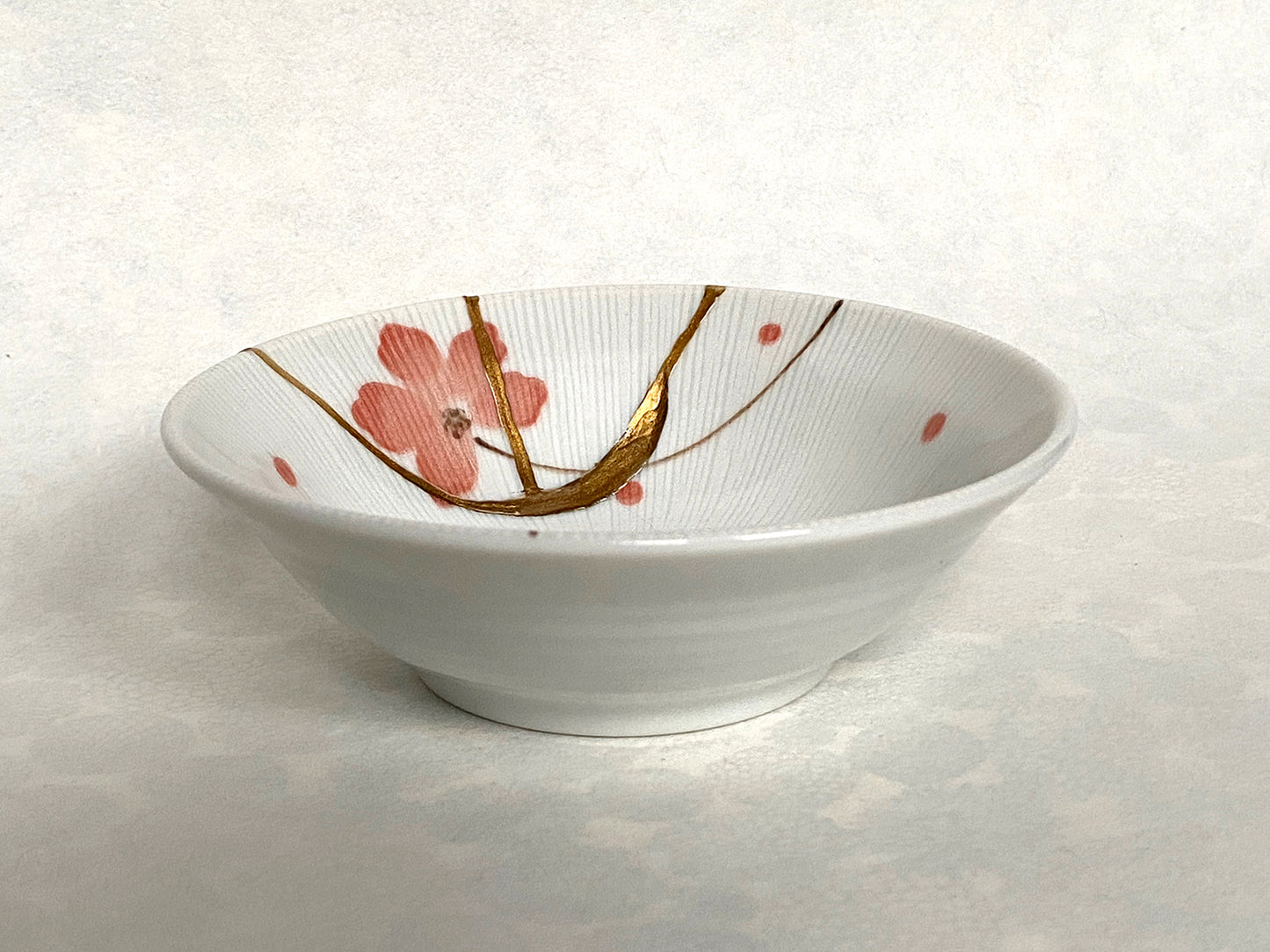 White ramekin with pink cherry blossoms