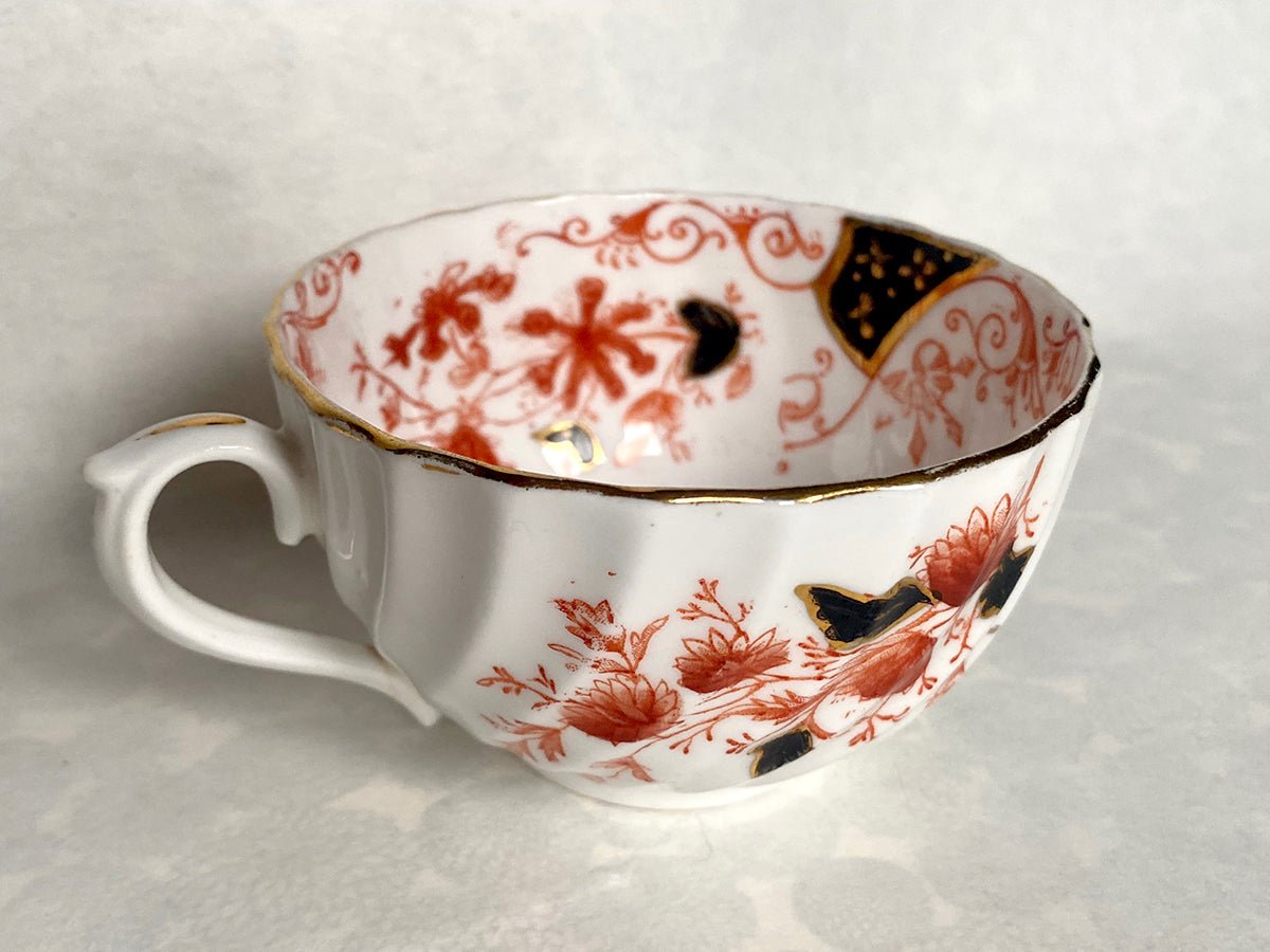 Ceramic white tea set with red and black floral pattern