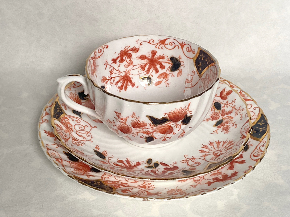 Ceramic white tea set with red and black floral pattern